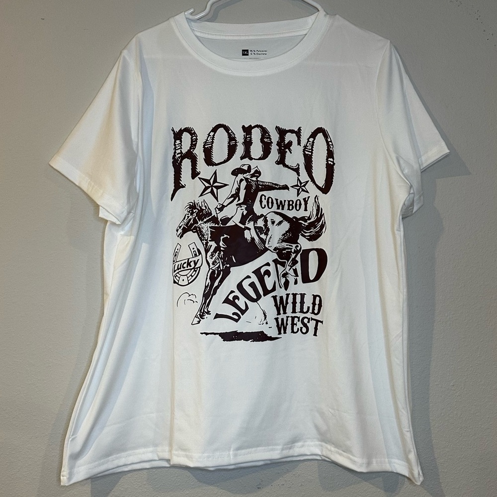 NWT‎ White rodeo T-shirt with brown print of a cowboy in a woman’s size 1XL.